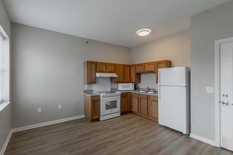 A kitchen with wooden cabinets and white appliances.