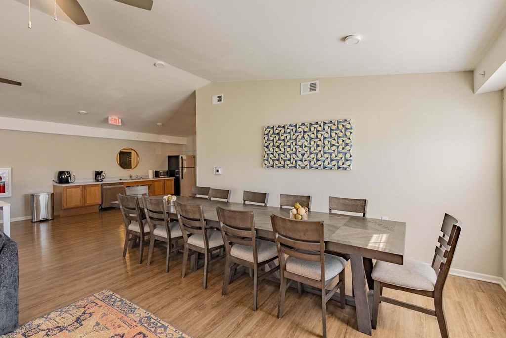 A dining room with a table set for six.