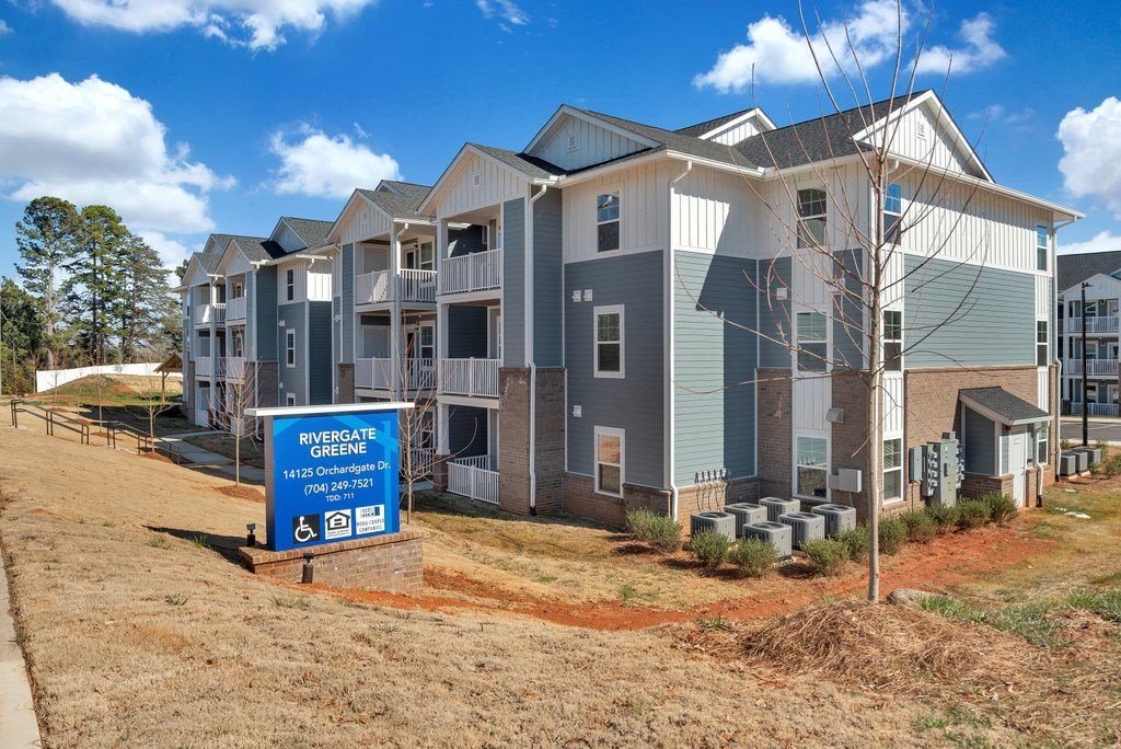 an image of an apartment building with a sign in front of it