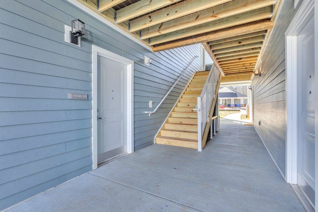 the front door of a house with stairs leading up to it