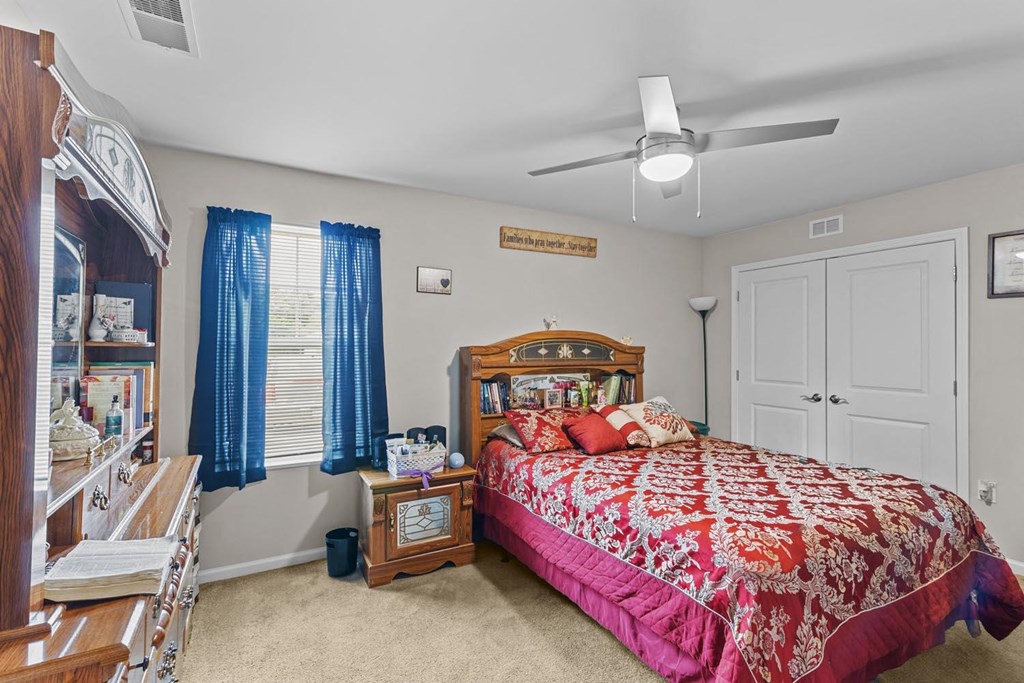 a bedroom with a bed and a closet