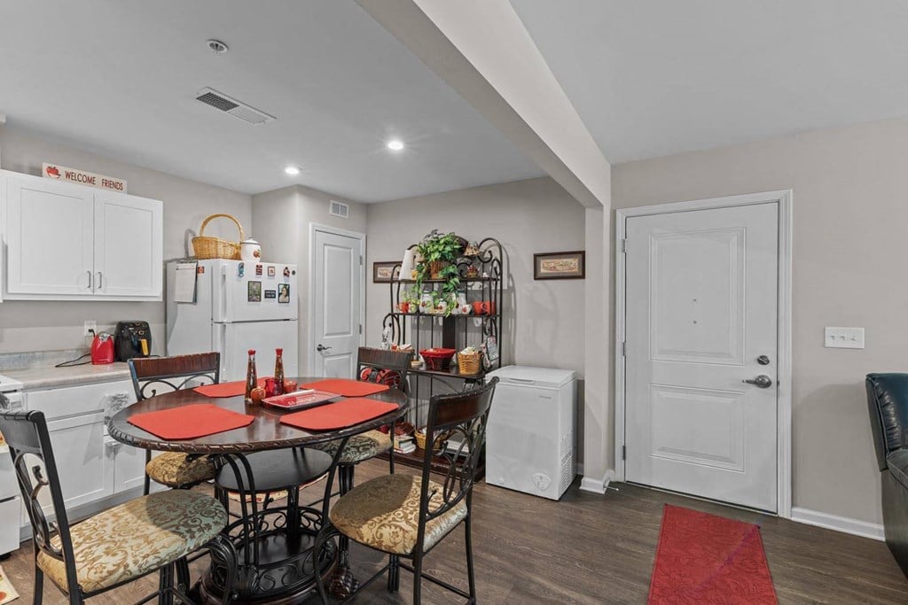 a kitchen and dining room with a table and chairs