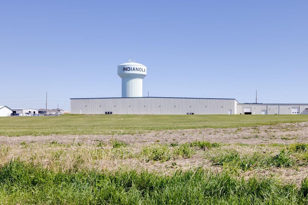 a water tower in the middle of a field