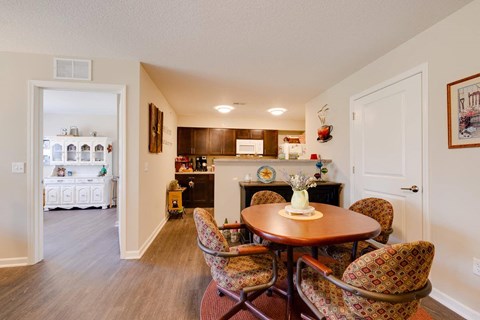 a dining room and kitchen with a table and chairs