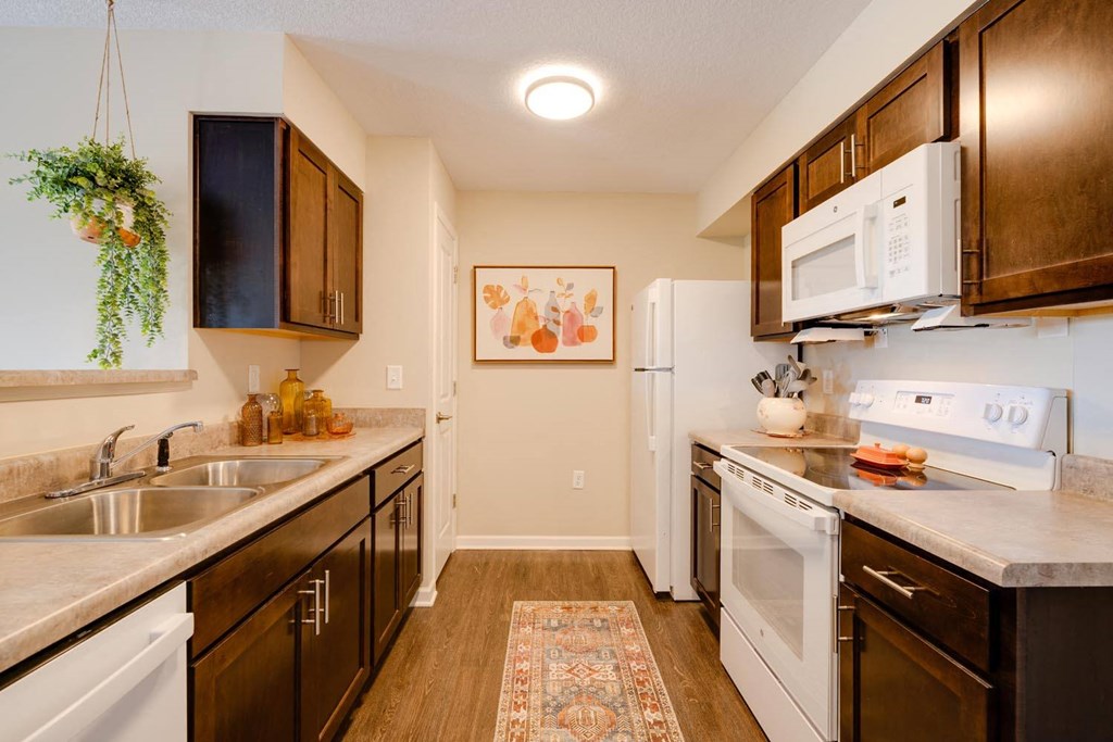 a kitchen with white appliances and wooden cabinets