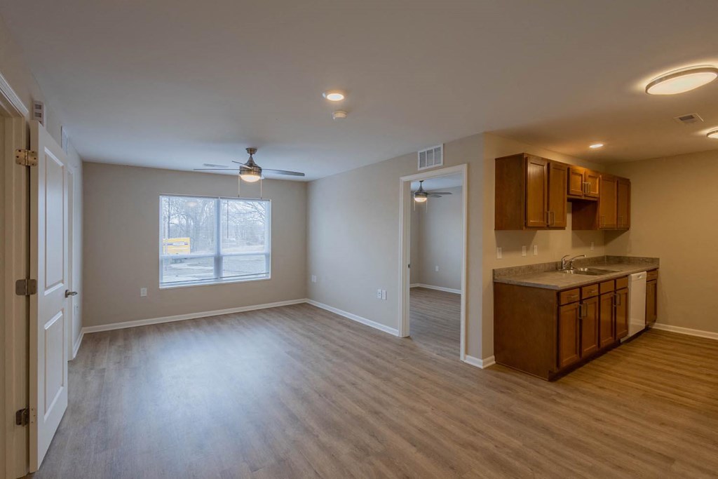A room with a window and a kitchenette.