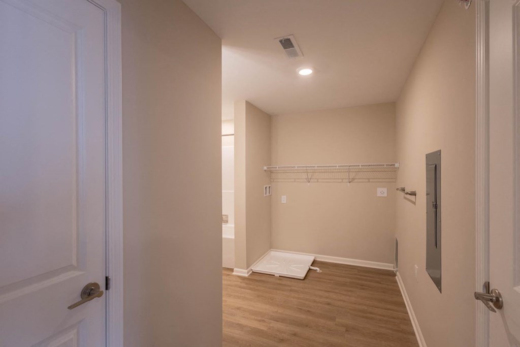 A long hallway with a door on the left and a door on the right.