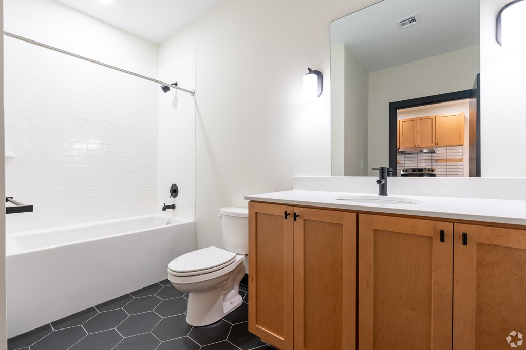 A white toilet sits next to a white sink in a bathroom.