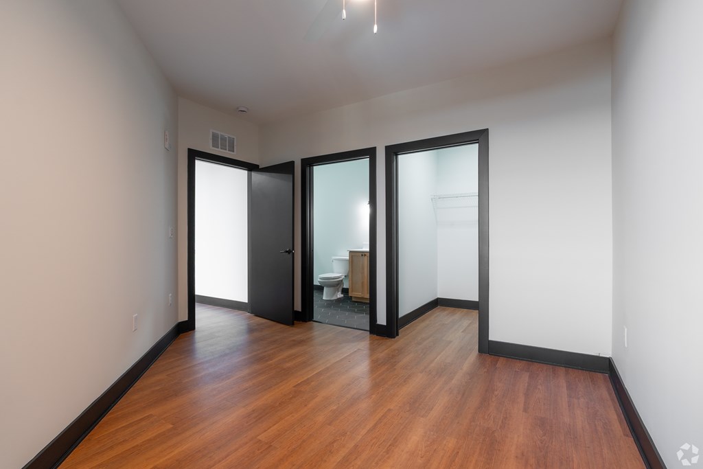 A room with wooden floors and white walls.