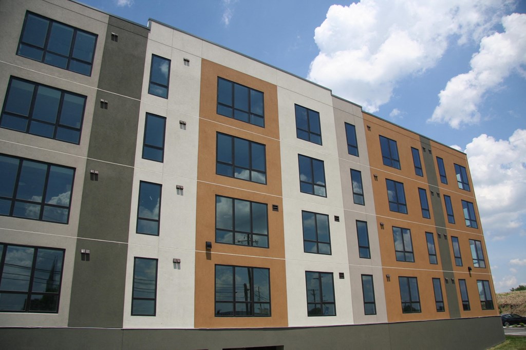 a large building with many windows and a blue sky