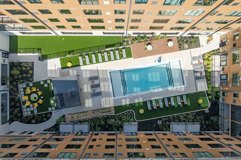 A modern building with a green roof and a pool.