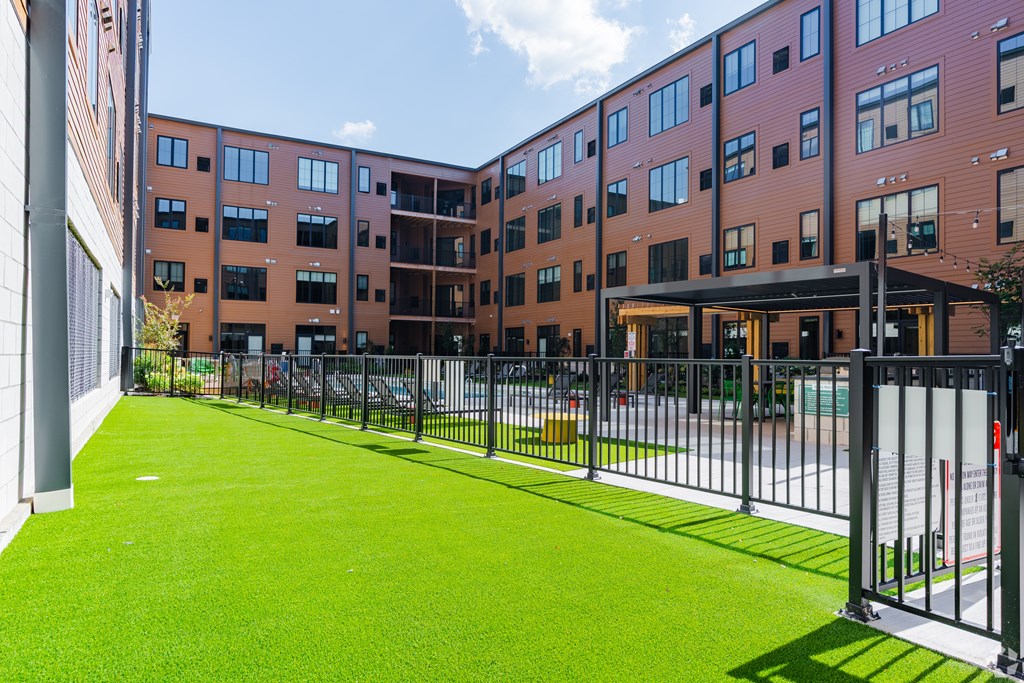 A building with a green lawn in front.