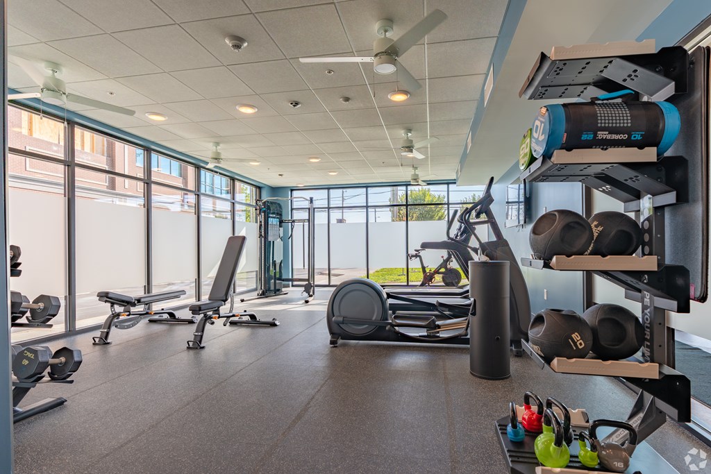 A gym with a variety of equipment including weights and exercise machines.