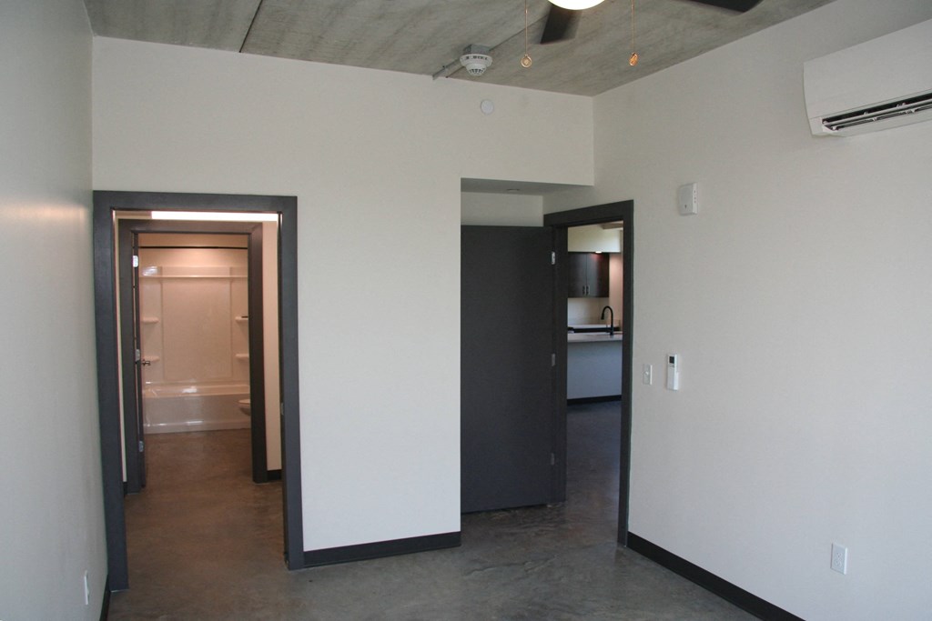 a view of a living room and a hallway with a door to a bathroom