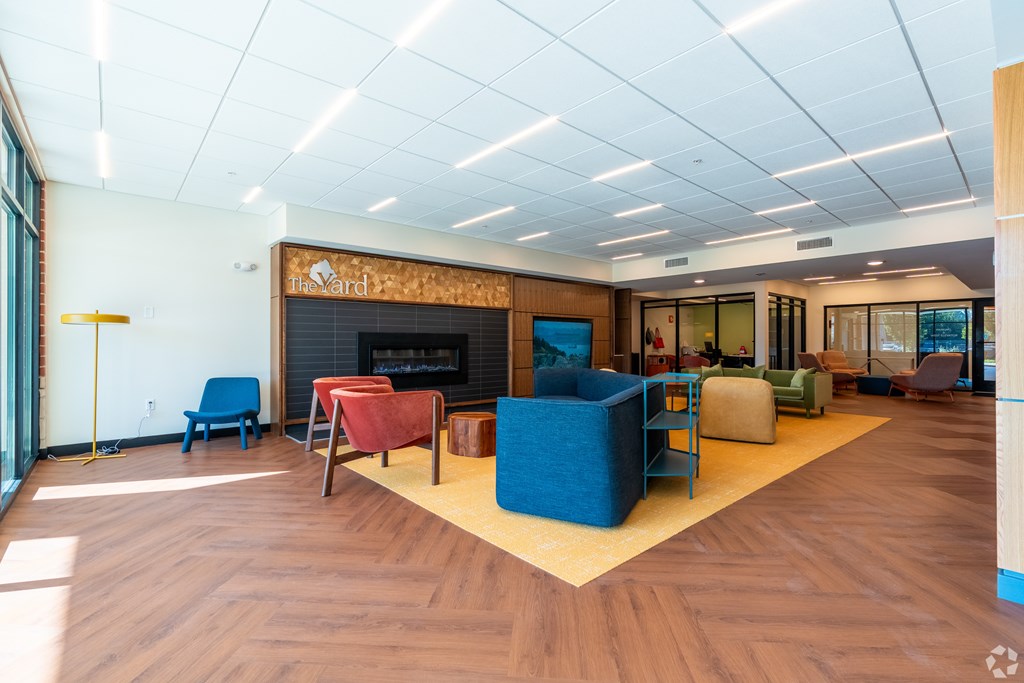 A room with a fireplace and a blue couch.