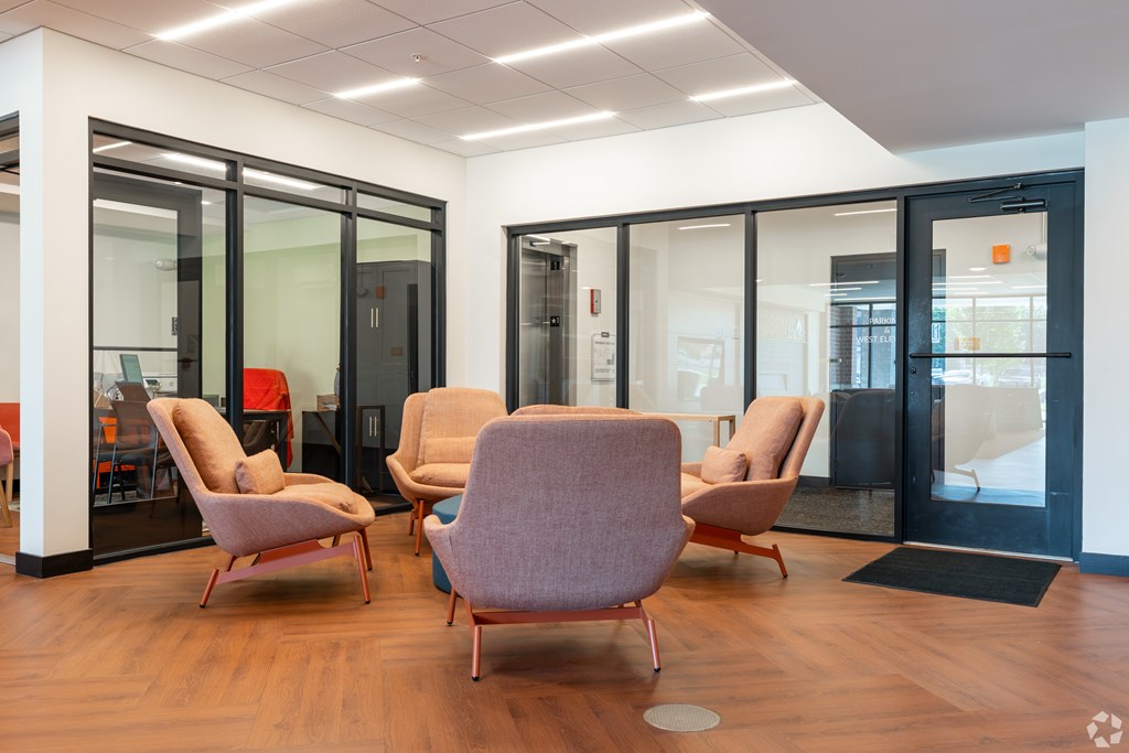 A room with a wooden floor and a black door.