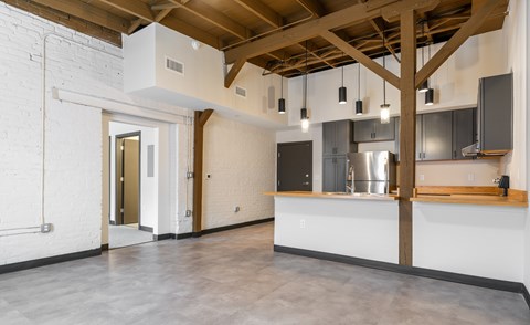 A kitchen area with a counter and cabinets.