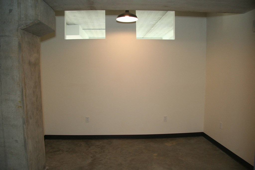 a living room with a white wall and two skylights