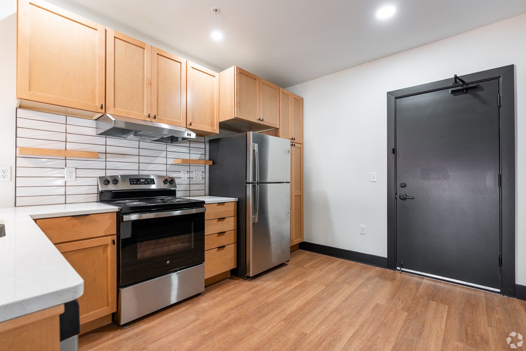 A kitchen with wooden cabinets and stainless steel appliances.
