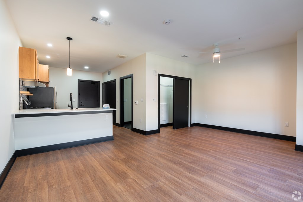 A reception area with a white counter and a black trash bin.