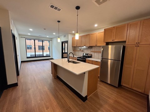 Kitchen with brown cabinets at The Yard Apartments, Kentucky, 40202