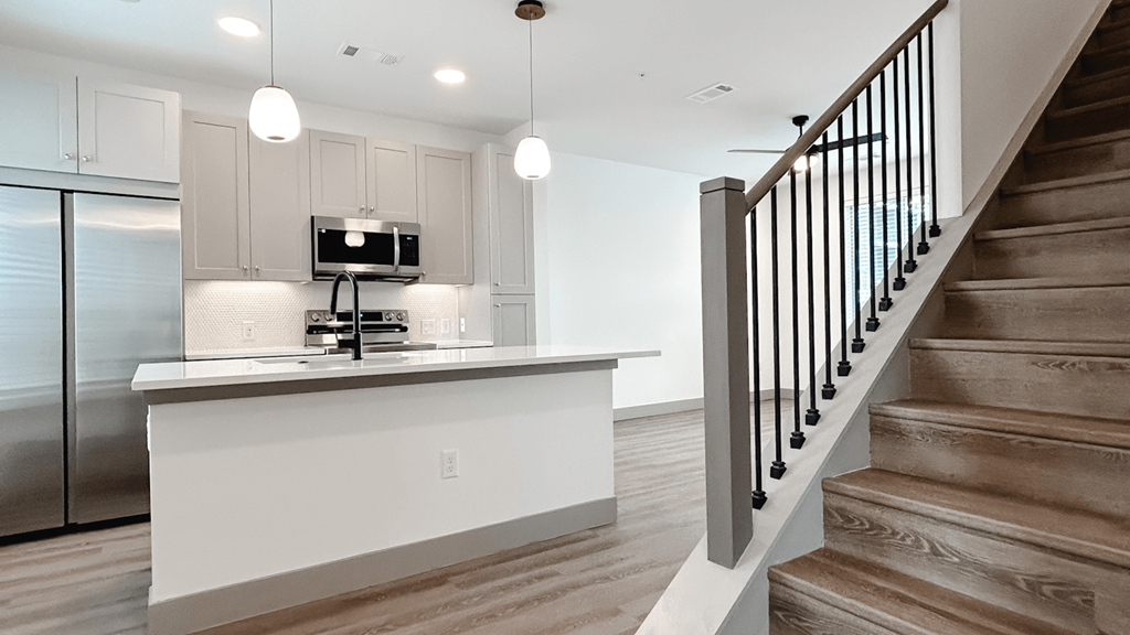 an open kitchen and stairs in a new home