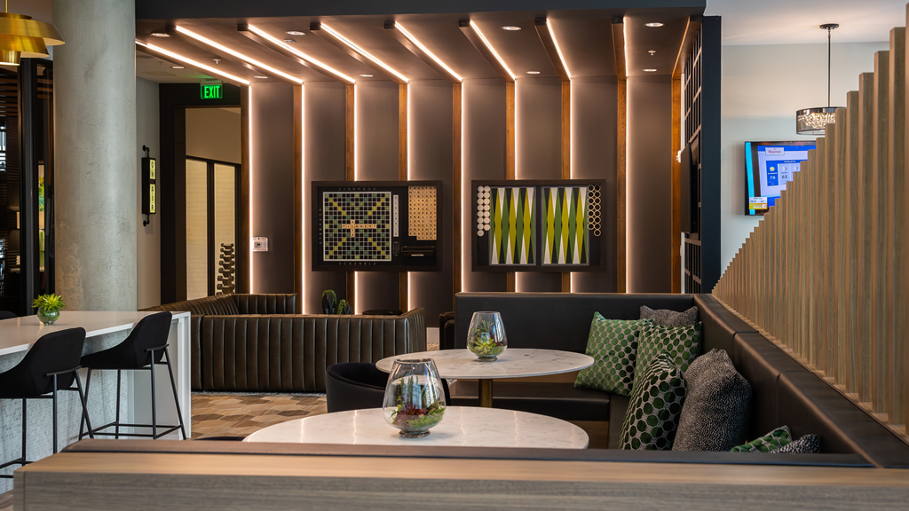 the lobby of a hotel with tables and chairs