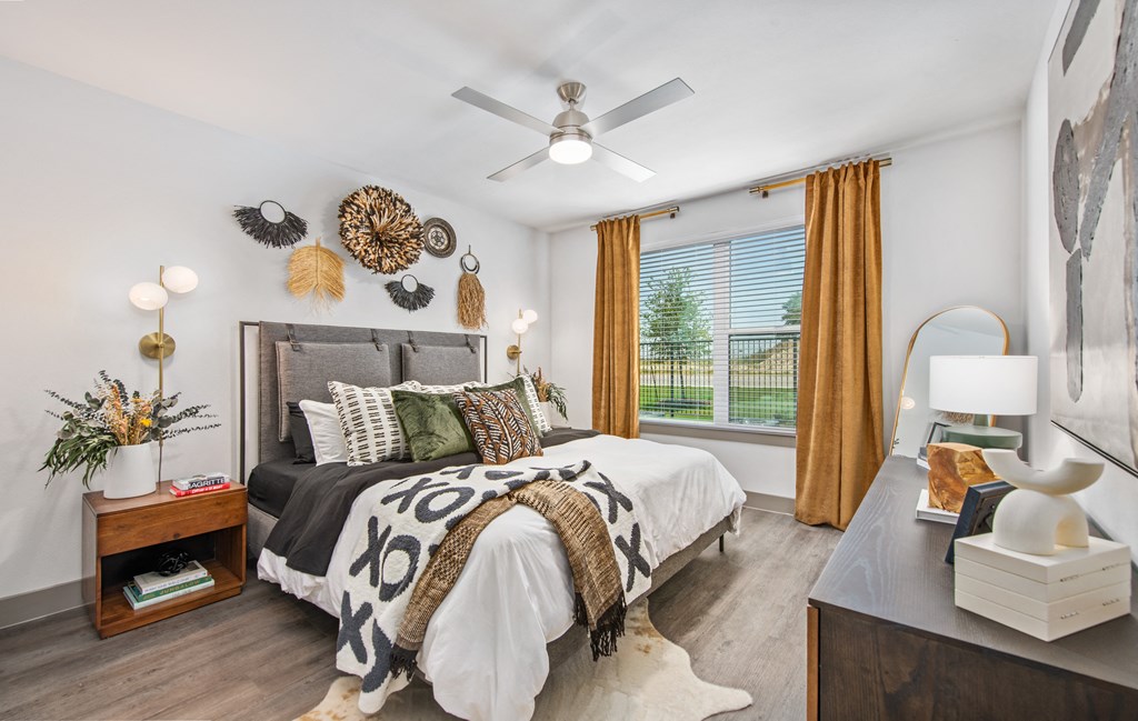 a bedroom with a bed and a ceiling fan