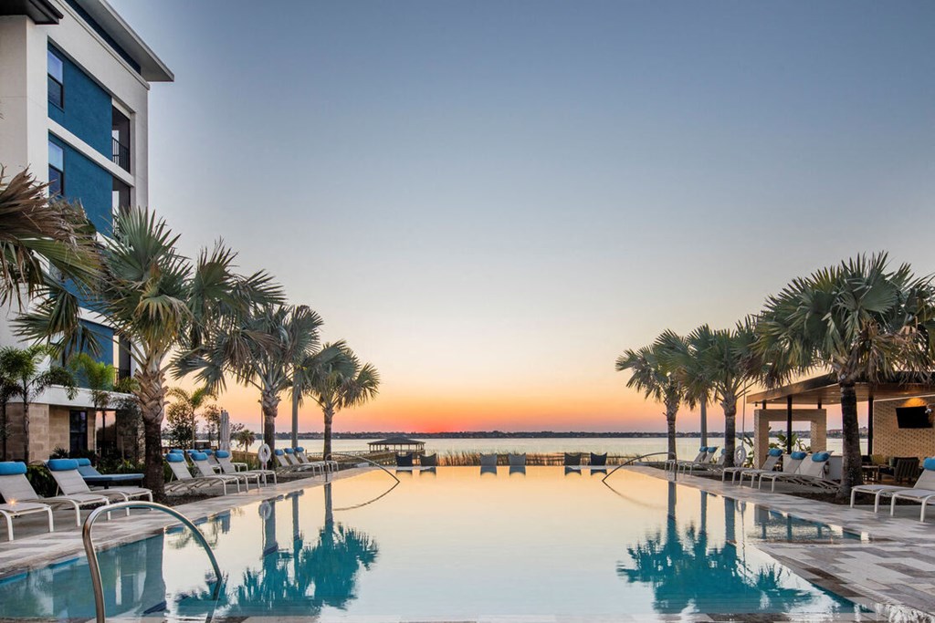 a swimming pool at sunset at the resort at longboat key club