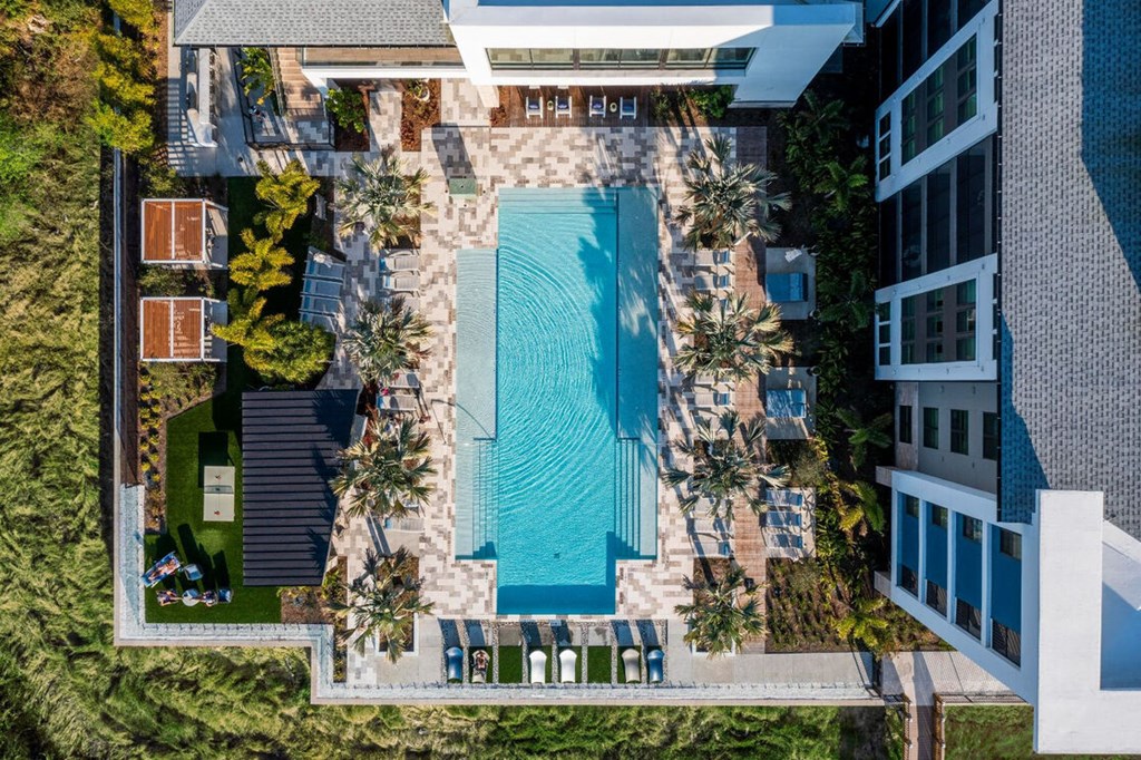 a rendering of the pool area of a building with a blue pool