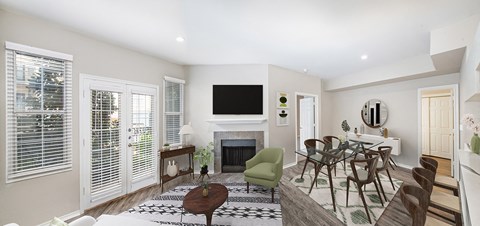 a living room with a fireplace and a table and chairs