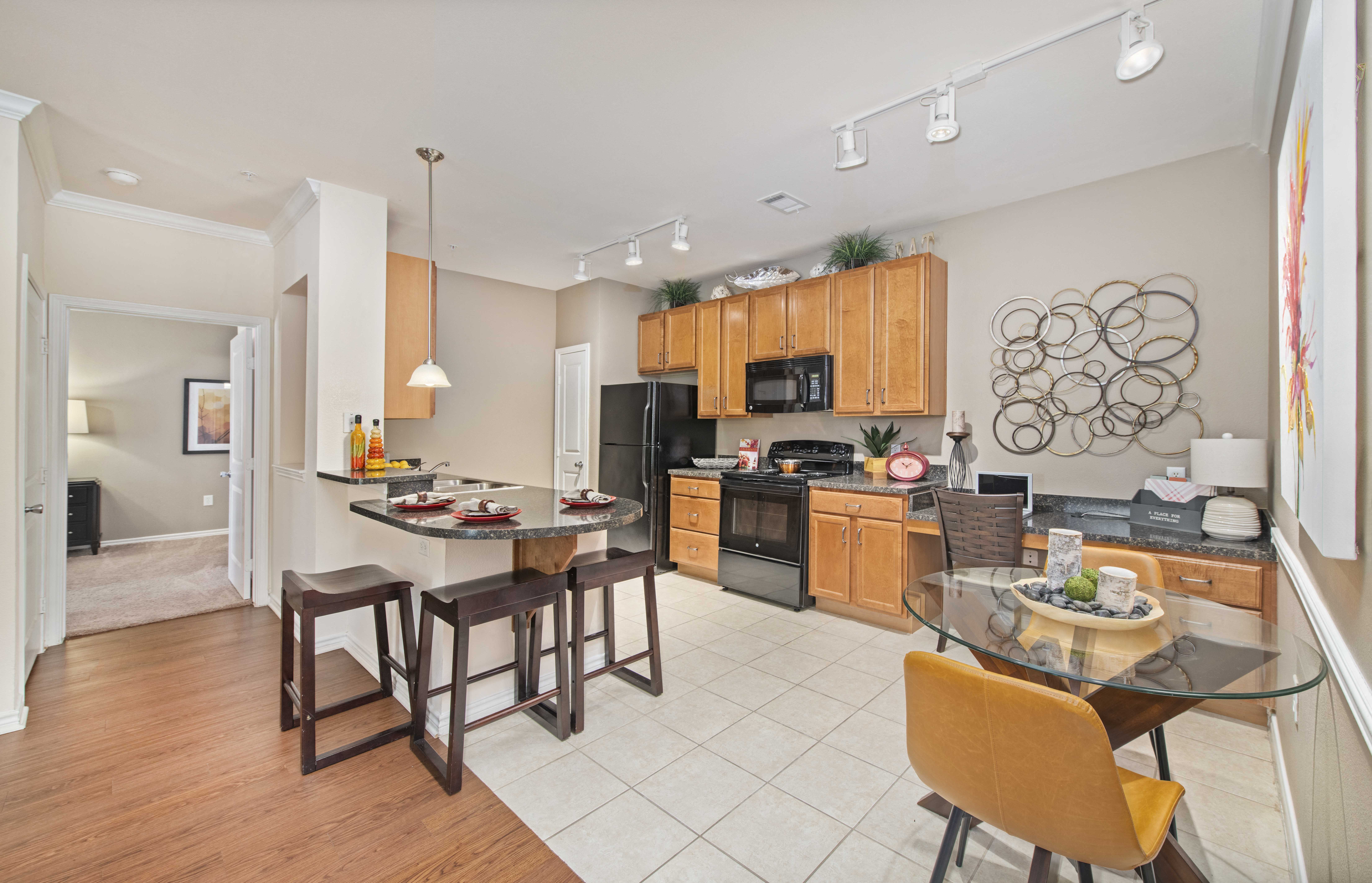 A kitchen with a table and chairs in the middle of the room.