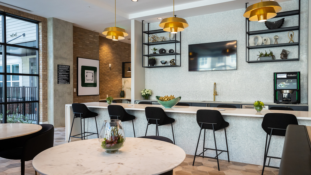 a kitchen and dining area with a table and chairs and a television