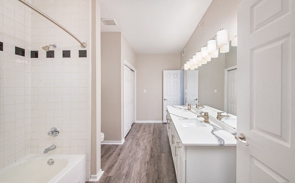 a bathroom with a long sink and a mirror