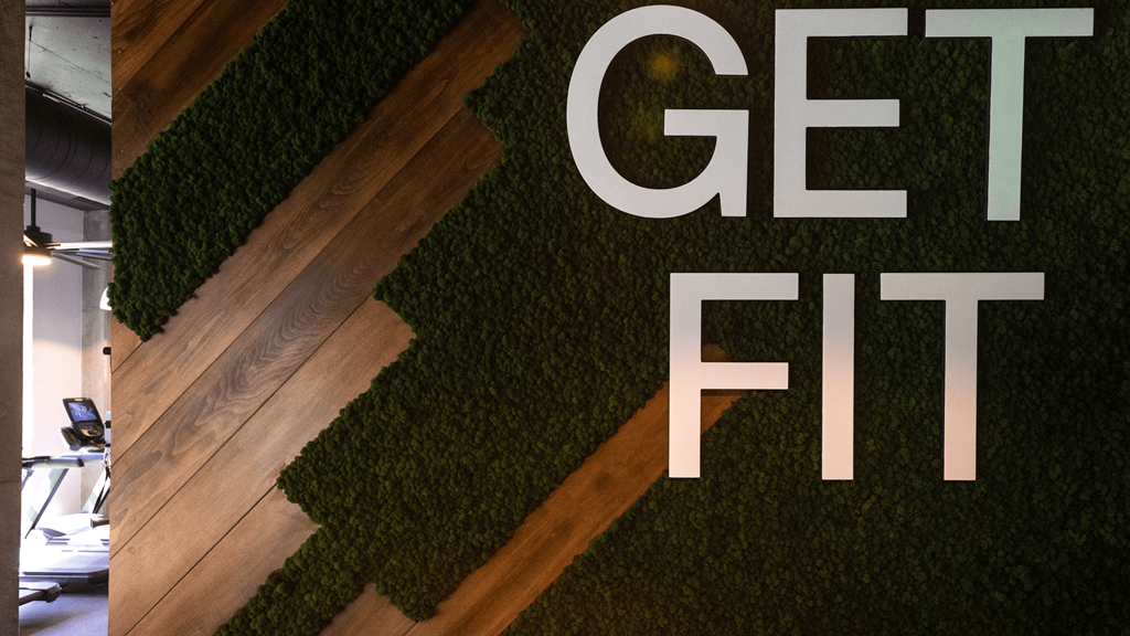 a wall with green grass and a wood floor and the word get fit on it