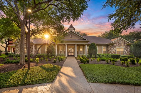 A house with a well-manicured lawn and a pathway leading to the front door.