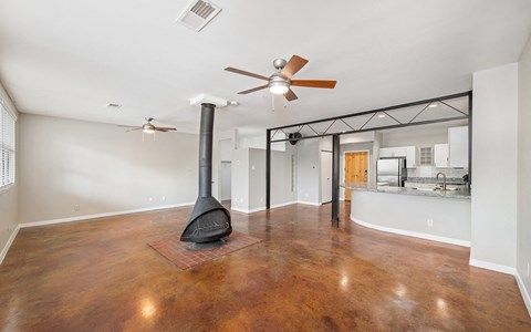 a living room with a fireplace and a ceiling fan