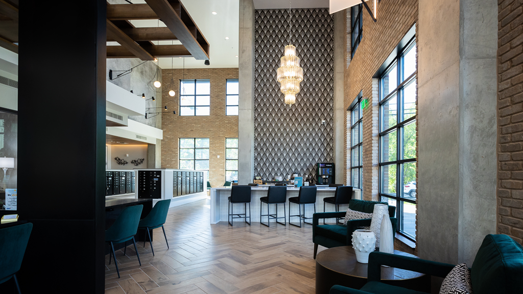 a large lobby with tables and chairs and a bar