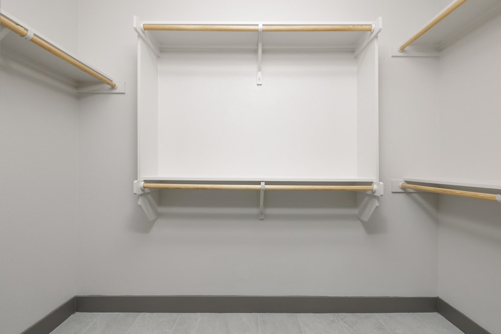 an empty room with a white wall and a white projector screen on the wall