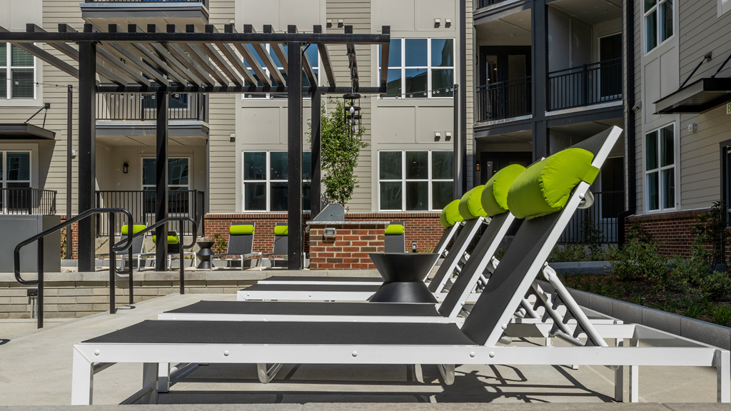 an outdoor play area with a seesaw at an apartment complex