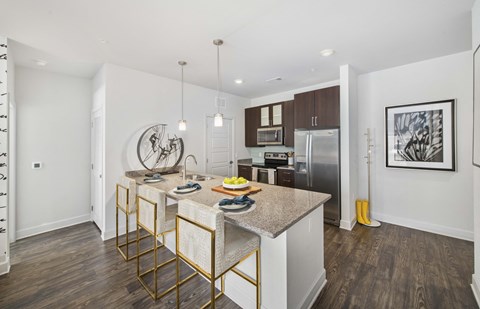 A kitchen with a table and chairs in the middle of it.