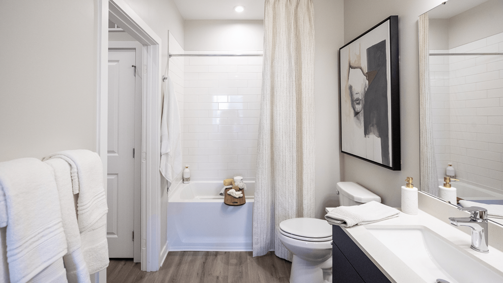 a bathroom with a toilet sink and tub and a shower