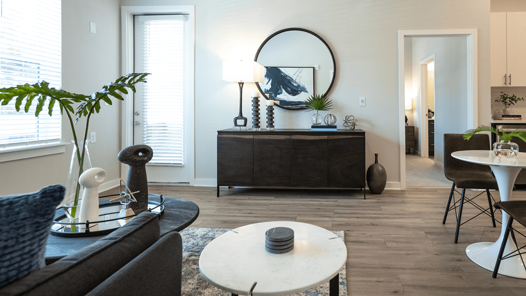 a living room with a couch and a table and a mirror