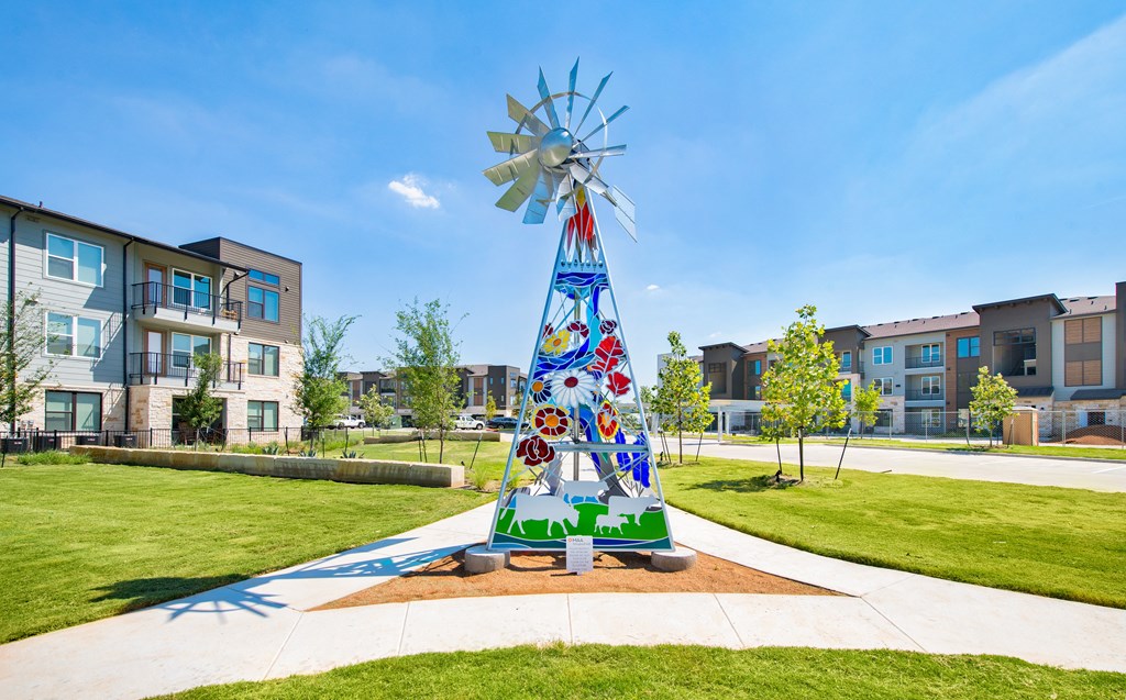 a sculpture of a christmas tree in front of an apartment building