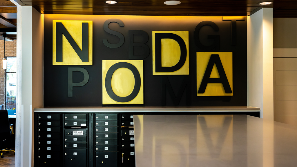 a large sign that reads no big deal on a wall next to some lockers