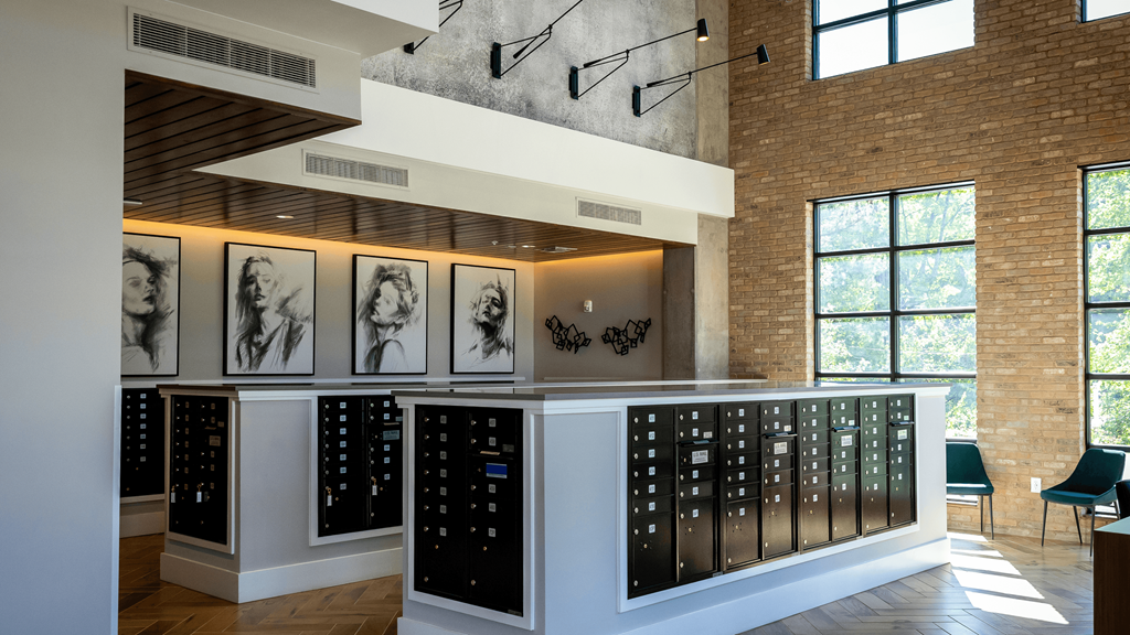 a display of watches in a room with a brick wall and windows