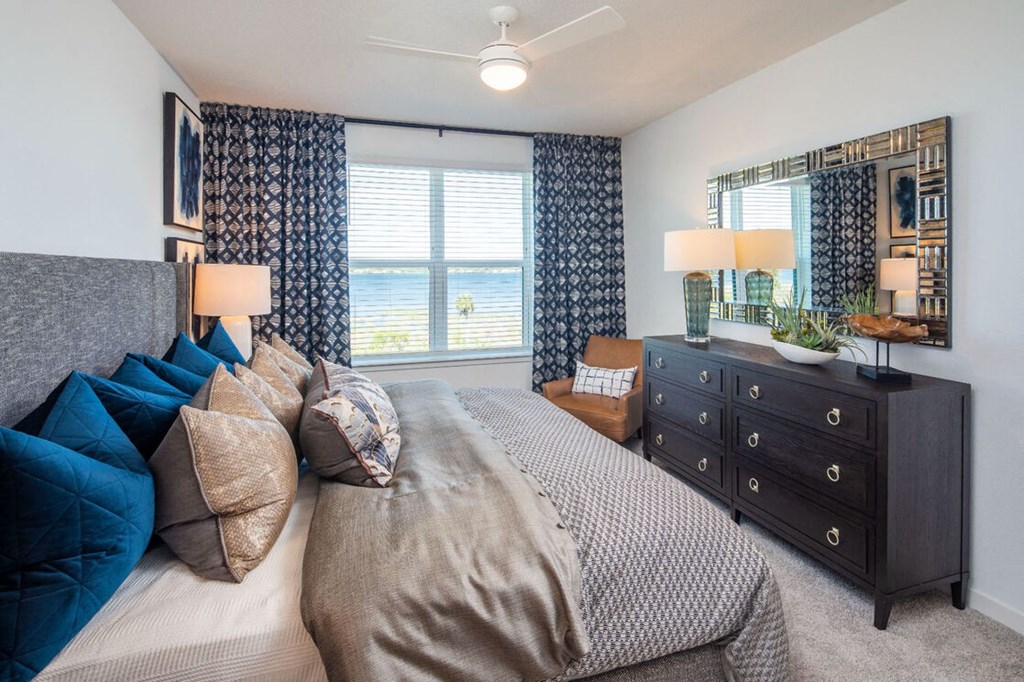 a bedroom with a large bed and a dresser