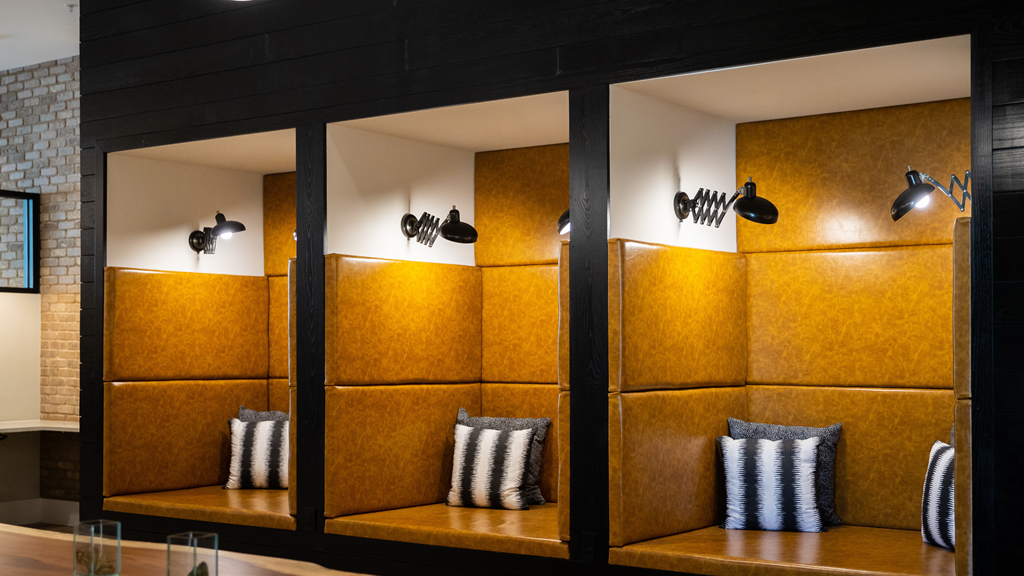 a seating area with yellow cushions in a window