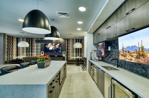 a kitchen and living room with a large screen tv