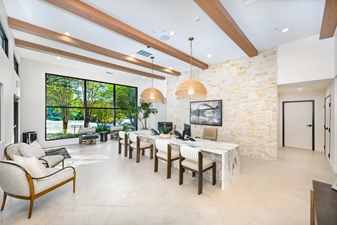 A modern living room with a stone wall and wooden beams.